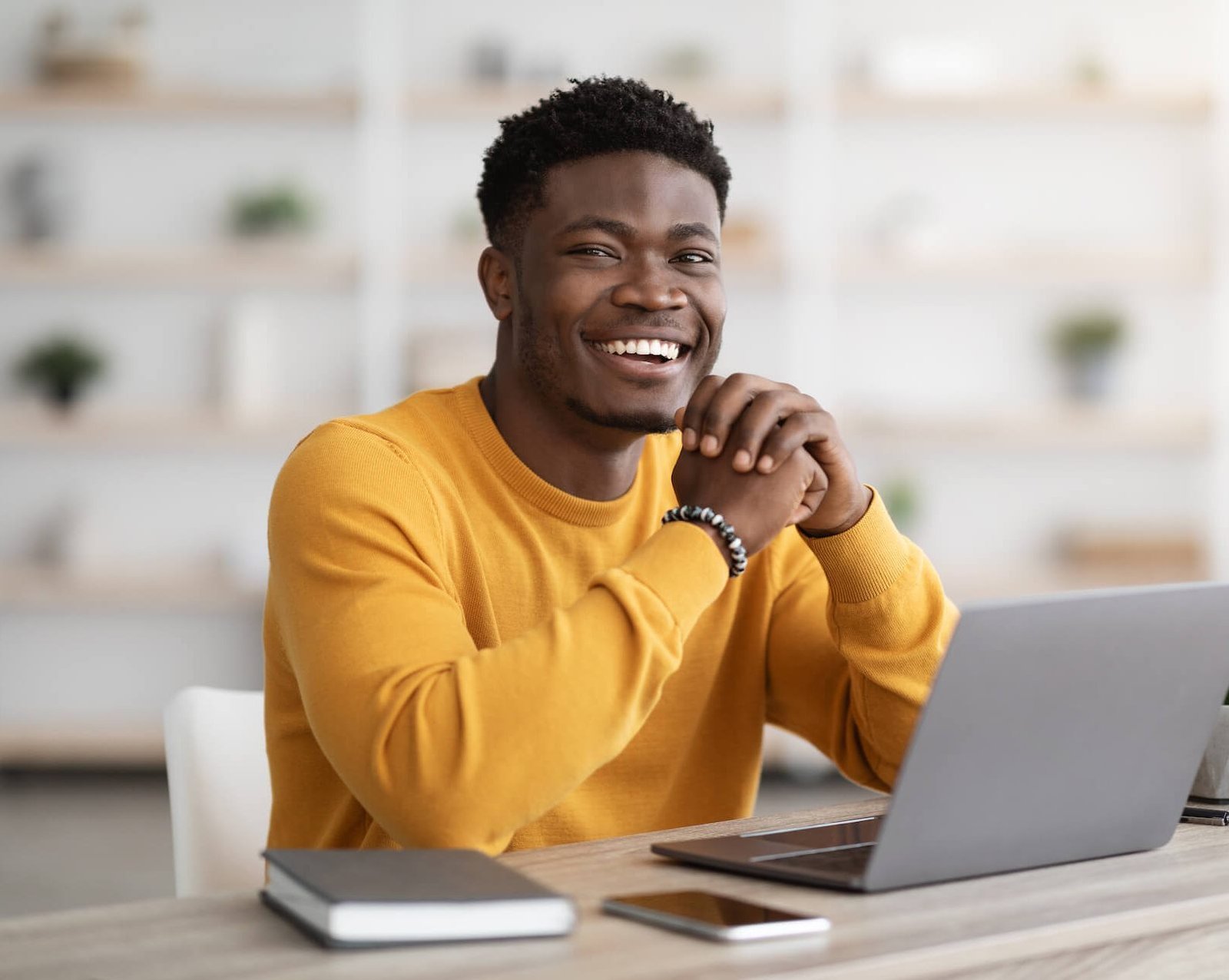 black-man-freelancer-sitting-at-workdesk-at-home-2022-12-16-08-26-37-utc-e1683773703351.jpg