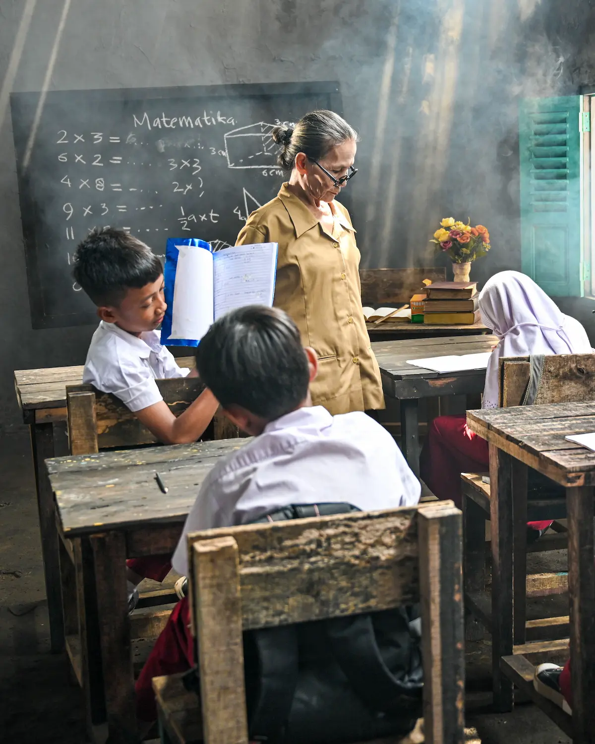 Teacher guiding students in a classroom